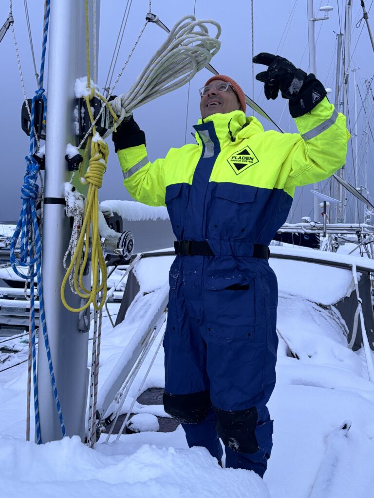 Iced and snowed in sailing yacht and frozen halyard